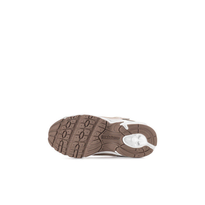 Toddler sneaker outsole with brown tread pattern and white sidewall