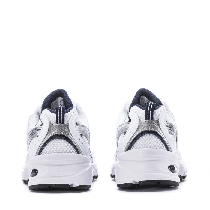 Women’s wide white sneakers showing heel and back mesh panels with navy trim.