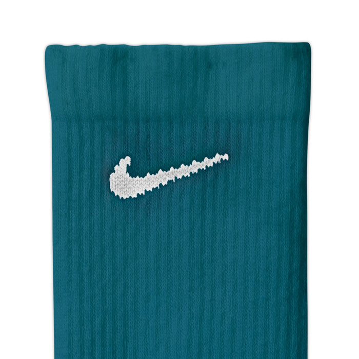Teal crew sock with white Nike Swoosh, ribbed knit and crew cuff