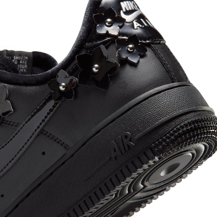 Women's black low-top sneaker close-up of AIR text and textured midsole