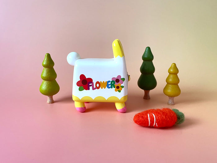 Box Rabbit by Rato Kim, a 4-inch tall limited edition toy bunny, posed among miniature trees.