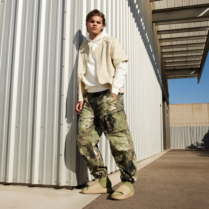 Khaki slide sandals on model with camo pants
