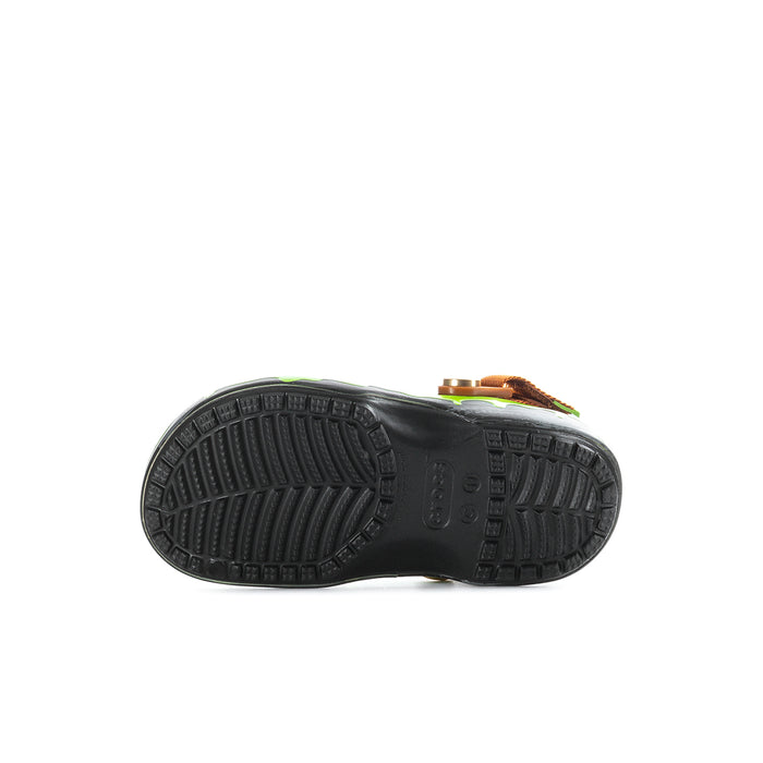 Kids clog outsole view, black textured tread with green upper and brown strap