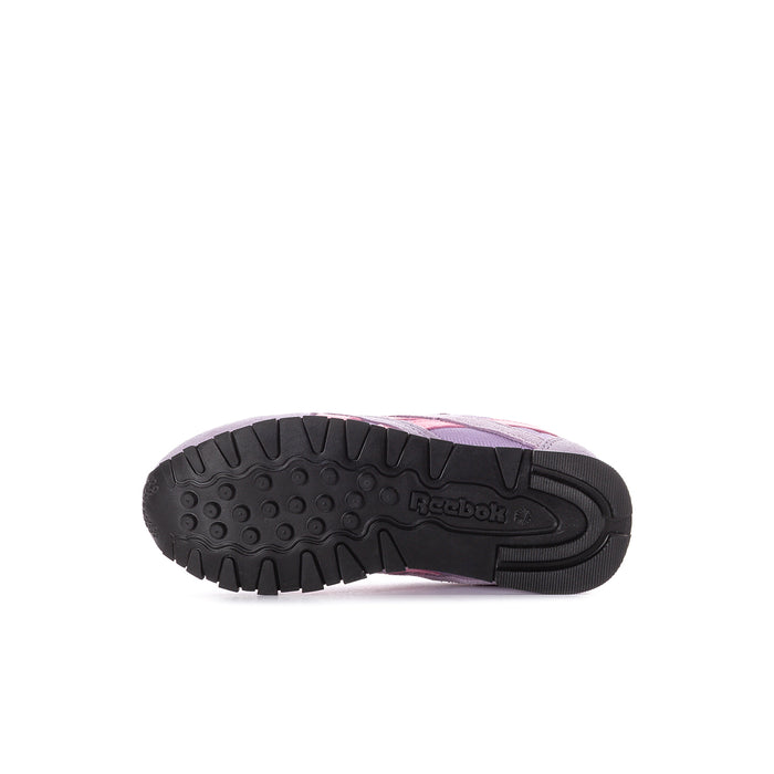 Kids' purple sneaker outsole with black tread and pink accent on midsole