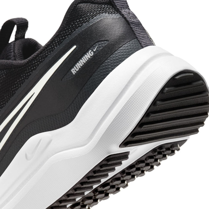 Youth running shoe side view close-up with white midsole cushioning and ribbed outsole