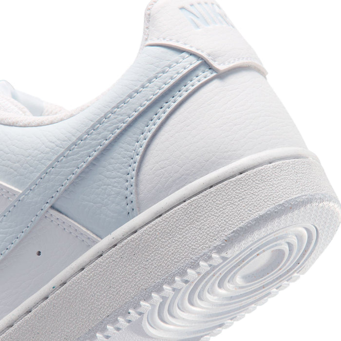 Close-up of women's white and light blue sneaker midsole and textured outsole.