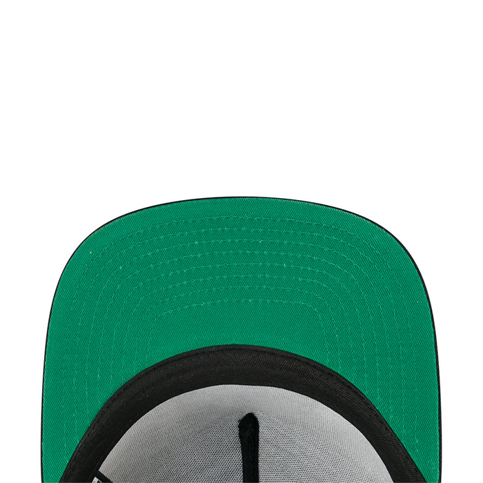 Green inner lining of a baseball cap with black brim edge