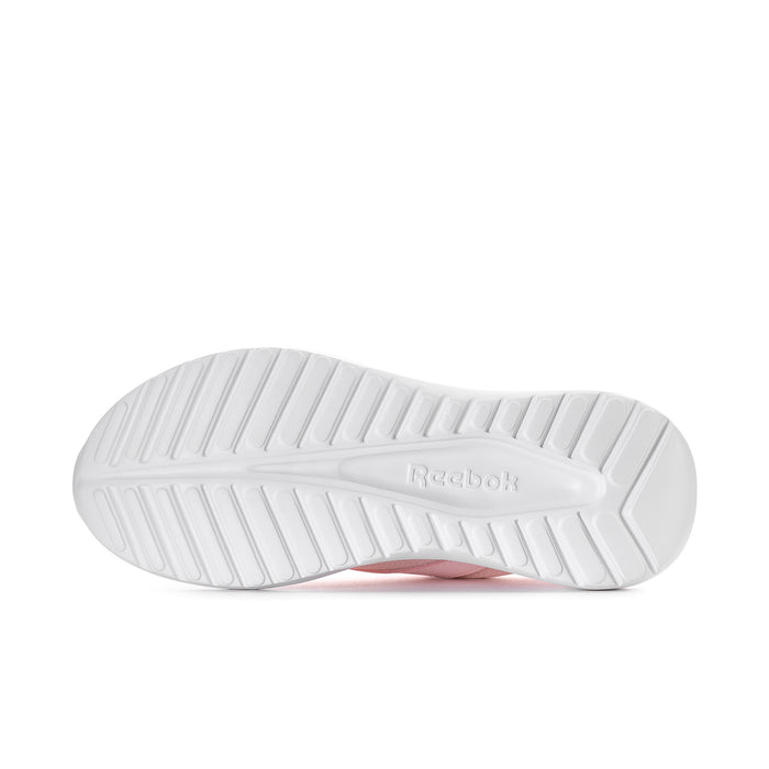White rubber outsole with Reebok branding and traction grooves on women’s sneaker
