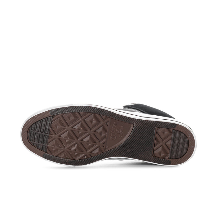 Converse mid-top sneaker outsole with tread, brown rubber bottom and white sidewall