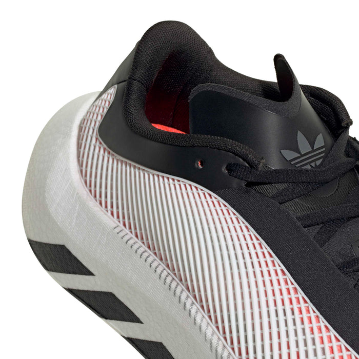 Close-up of men's black sneaker heel with red grid lining and adidas-style logo