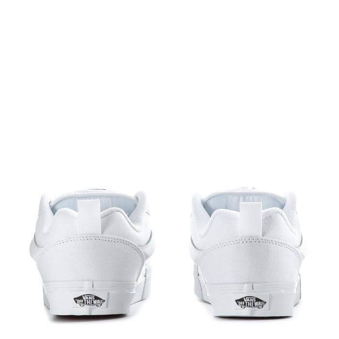 Youth white low-top sneaker with rear logo patch and cushioned heel