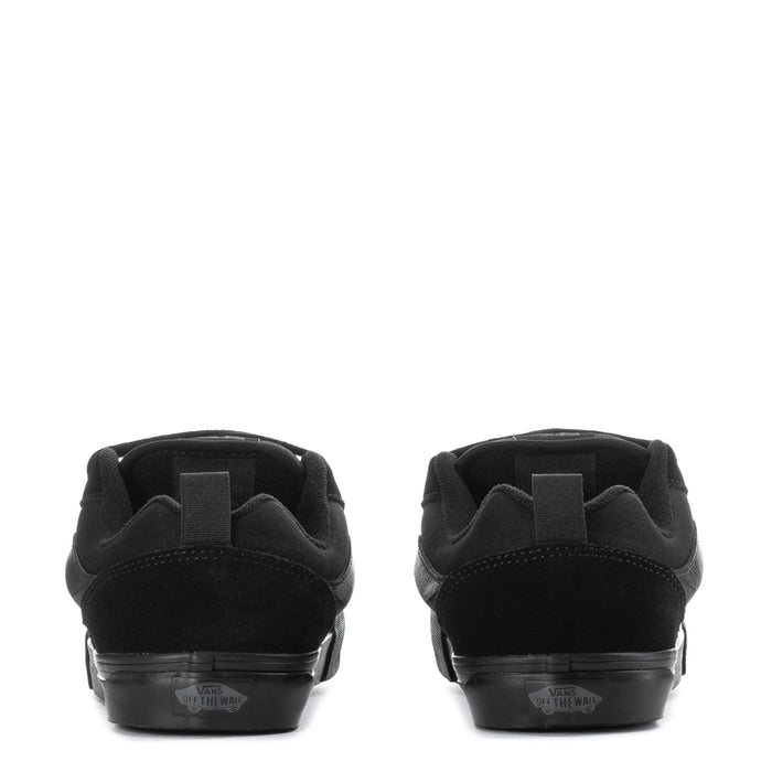 Youth black sneakers heel view, padded collar and rubber sole with rear label