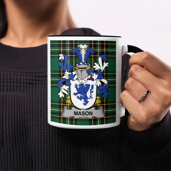 White mug with black rim displaying a green plaid pattern and the Mason family crest.