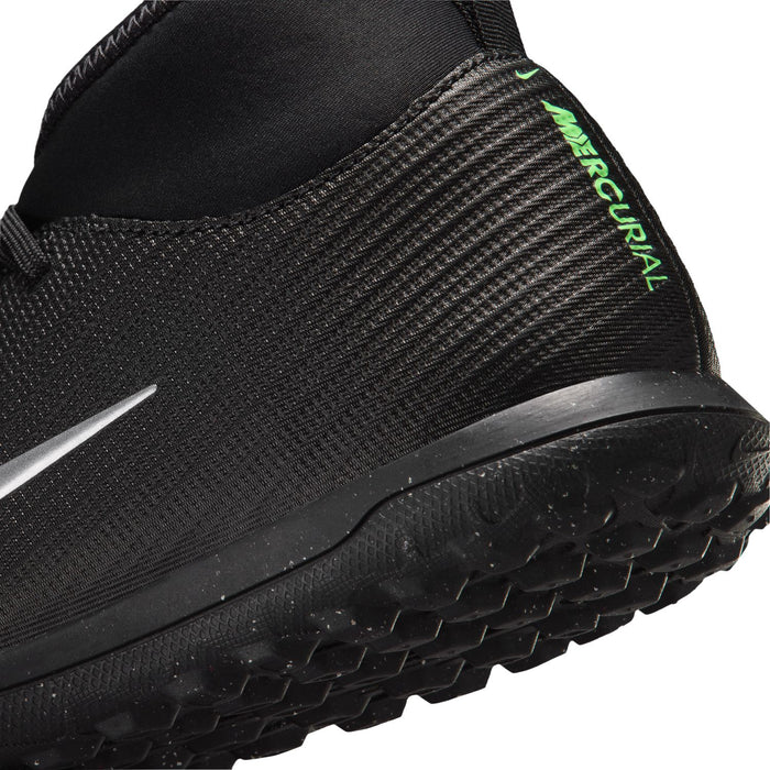 Youth cleat side close-up: black knit upper with neon green heel text