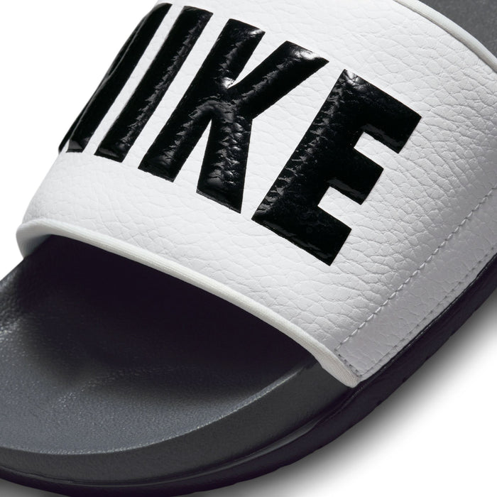 Men's slide sandals close-up: white textured strap with black Nike lettering