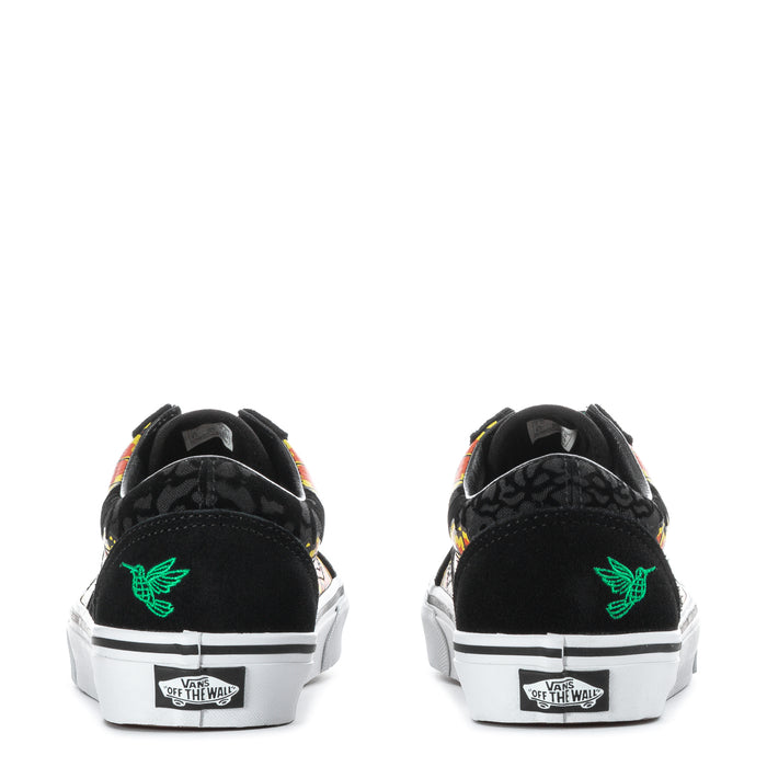 Black sneakers with green flying-V logo, marigold heel artwork, and white sole
