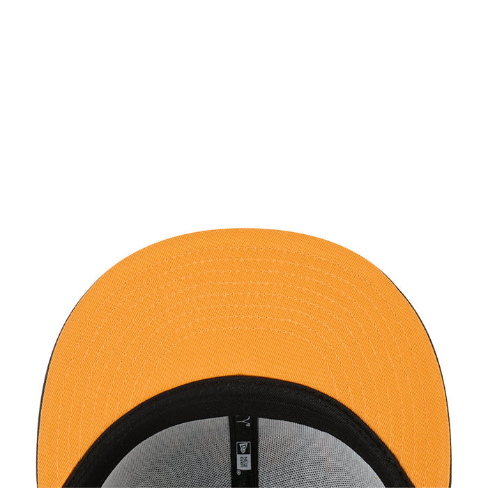 Orange baseball cap close-up of crown and black inner band with interior tag