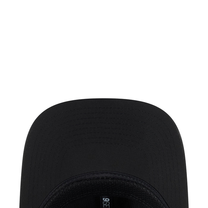 Black cap crown close-up with stitched panels and ventilation eyelets