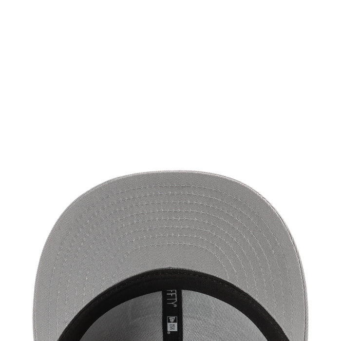 Grey baseball cap close-up of brim with black inner band and New Era label