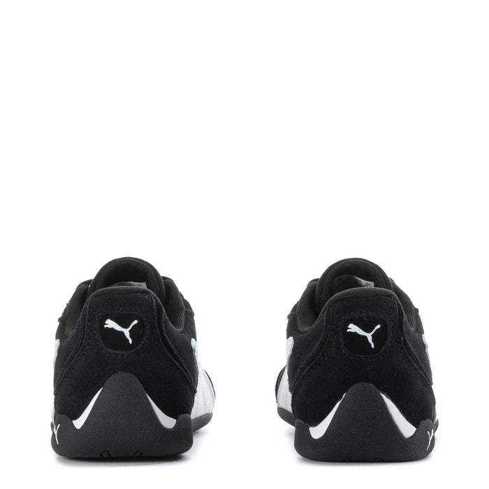 Youth black Puma suede sneakers, heel view with white logo accents