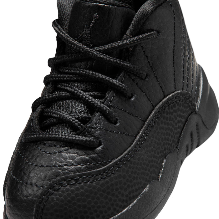Black toddler high-top sneaker close-up with lace-up, textured leather, and stitching