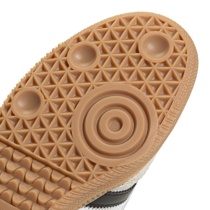 Close-up tan traction outsole with patterned dots and round rubber grip pods