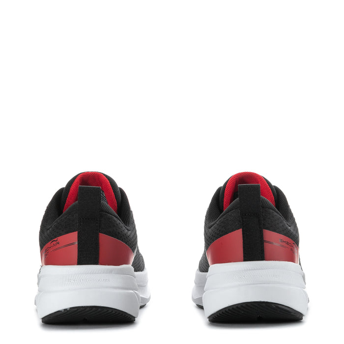 Youth black sneakers rear view with red heel panel and white cushioned sole
