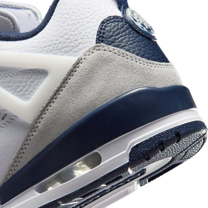 Men's low-top sneakers close-up, navy midsole with visible air cushioning window