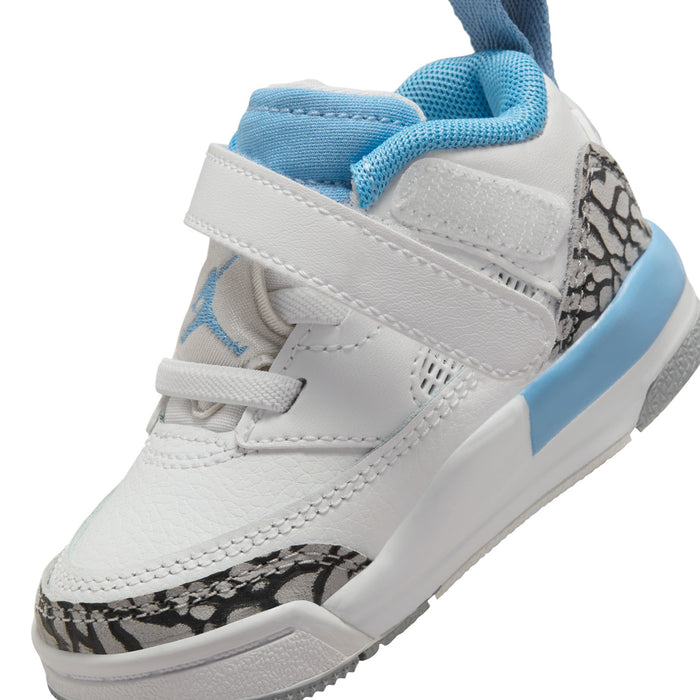 Toddler low-top sneakers close-up; white upper with light blue collar and side leopard panel