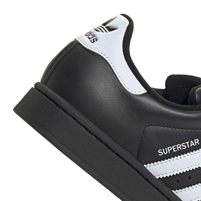 Close-up of women’s adidas Superstar II heel with white adidas label and black leather