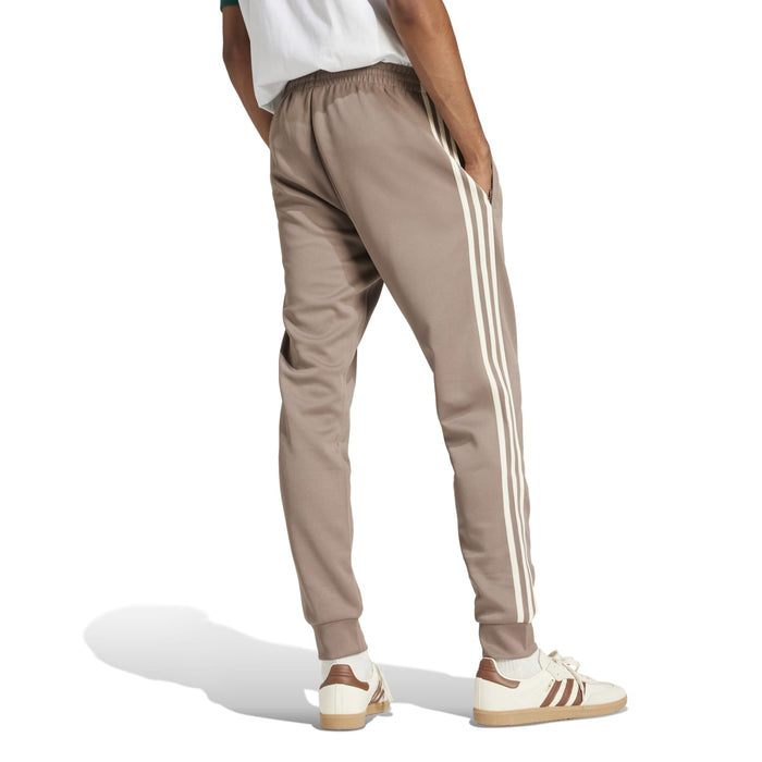 Men's taupe track pants with white side stripes and tapered fit