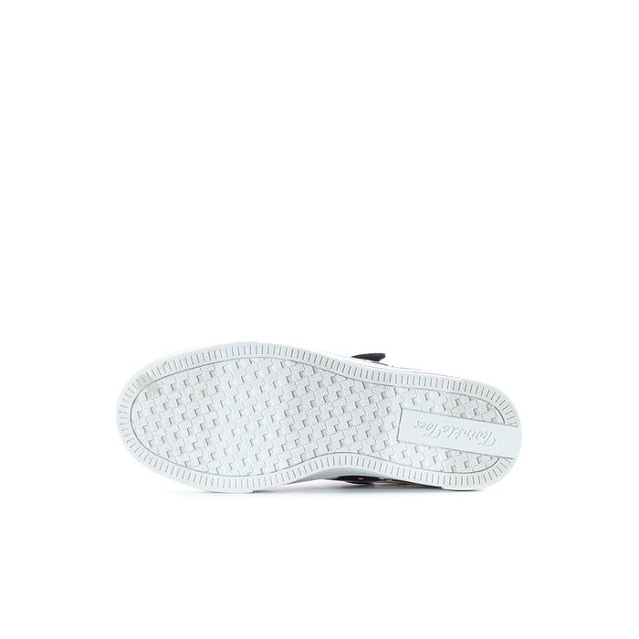 Kids sneaker outsole with white tread pattern and dark stripe near the heel