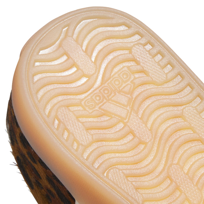 Close-up of youth outsole tread with wavy lines and embossed pattern
