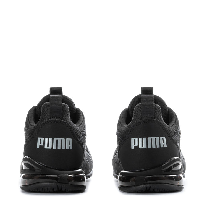 Youth black Puma sneakers back view with PUMA logo and cushioned heel