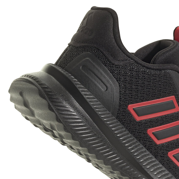 Youth black sneaker with ruby red side stripe panel and textured traction sole