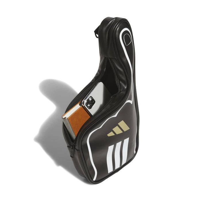 Black finger crossbody bag with white piping, gold logo, and tan front clasp