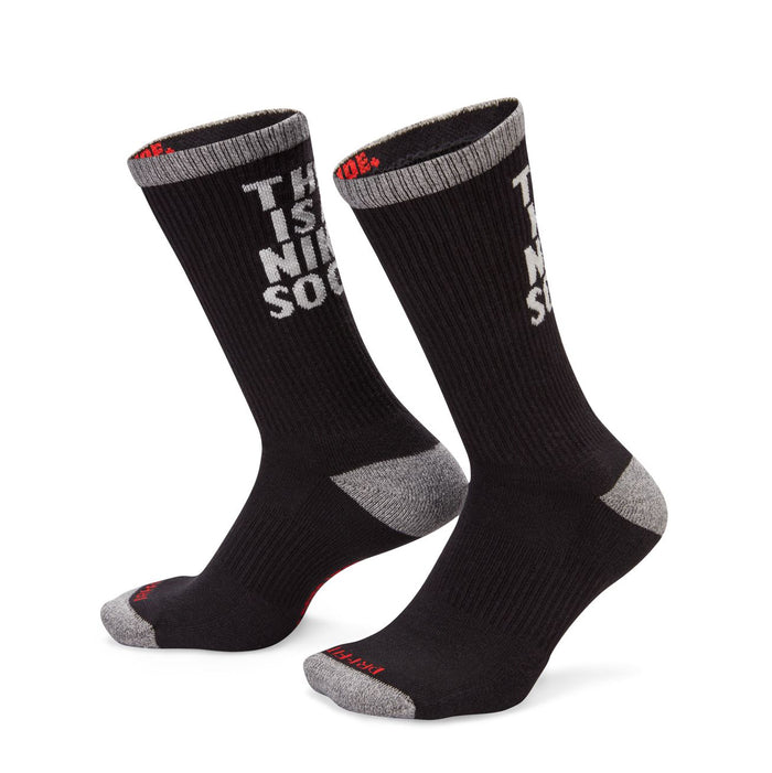 Black cushioned crew socks with gray toe/heel and 'THIS IS A NIKE SOCK' on the shaft