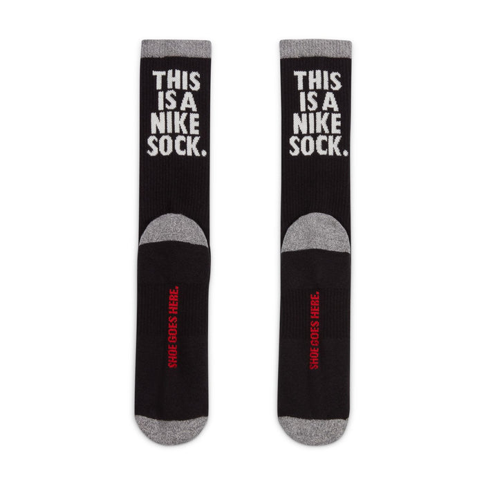 Black crew socks with gray toe/heel and white 'THIS IS A NIKE SOCK' text on legs