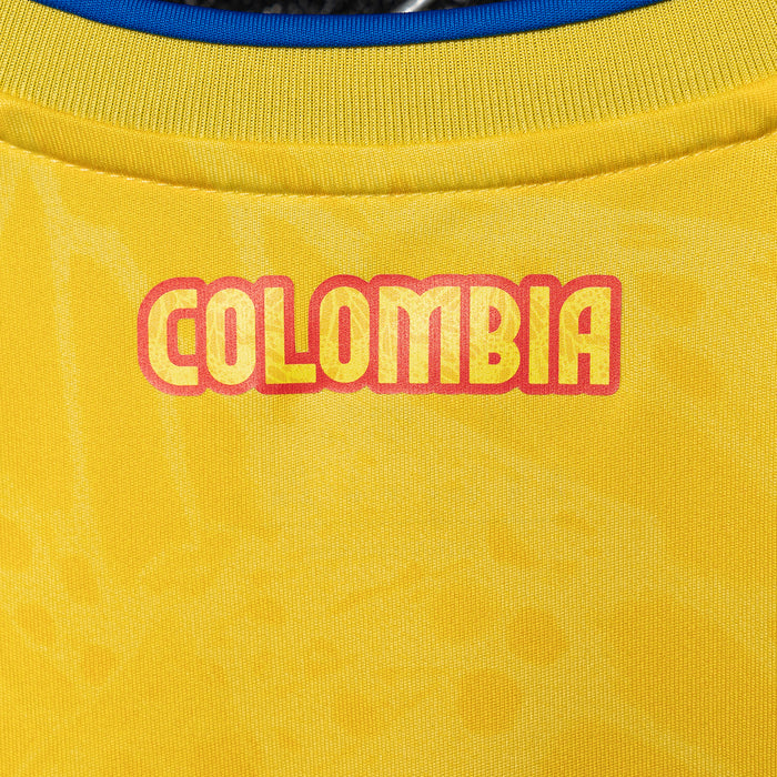 Close-up of 'Colombia' text on yellow jersey collar