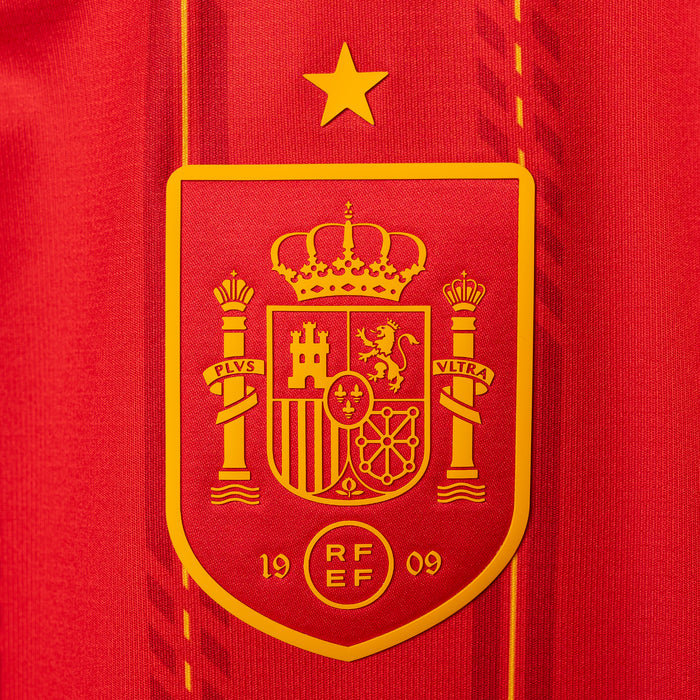 Spain crest badge on vivid red jersey with gold star above shield