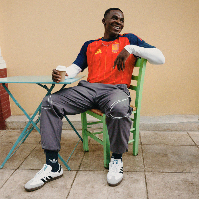 Spain replica home jersey in vivid red with navy sleeve panels and gold Adidas logo