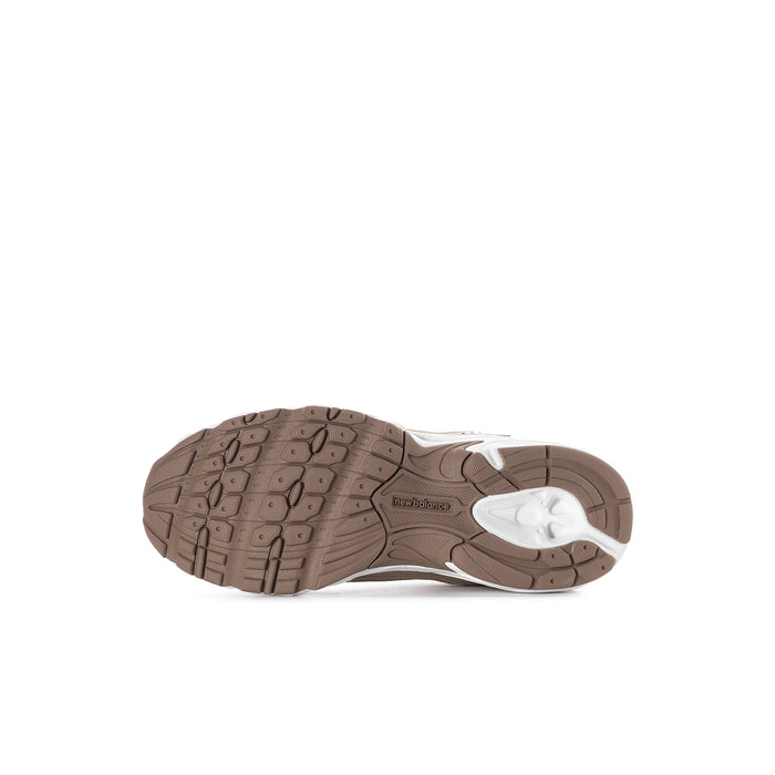 Kids beige sneaker outsole tread with white midsole on athletic shoe