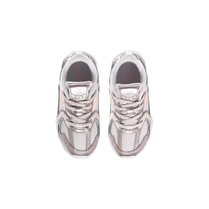 Toddler sneaker pair with light pink lace-up uppers and white rubber toe caps