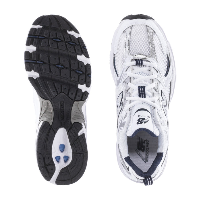 Women’s wide white sneakers showing treaded outsole and mesh upper details.