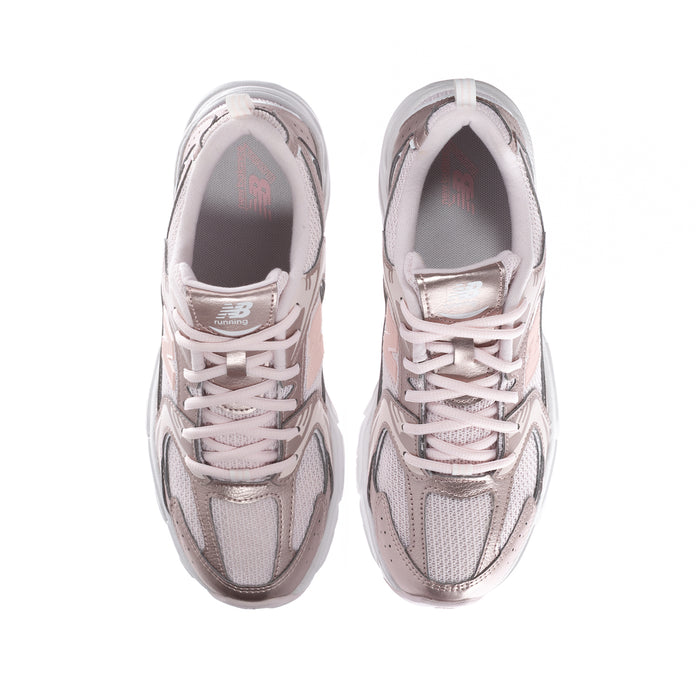 Youth pair of light pink sneakers, front view with lace-up closure and padded collars.