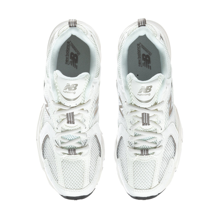 Pair of off-white New Balance 530 wide sneakers with lace-up front and padded collars