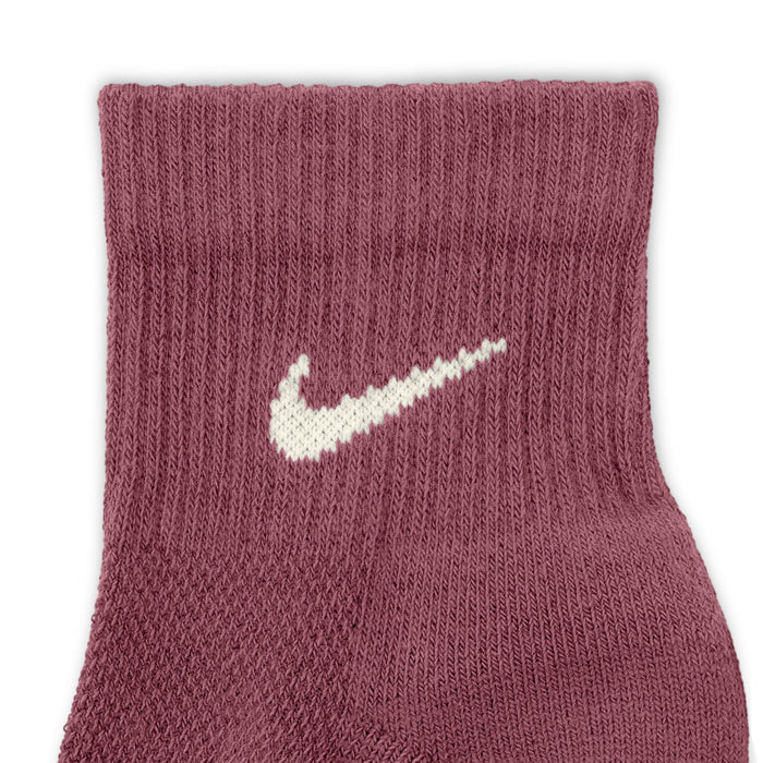 Maroon knit quarter sock with white Nike swoosh logo on the foot