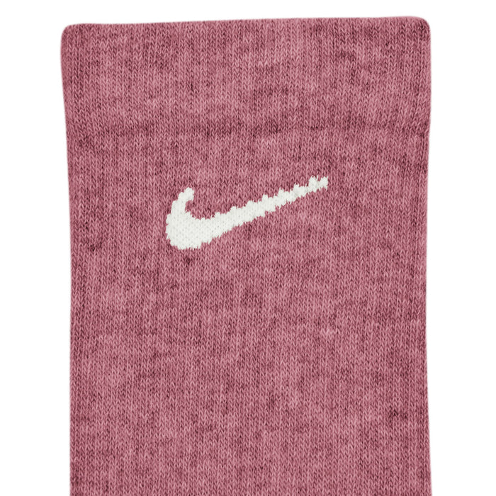 Ribbed crew sock close-up in dusty pink with white Nike swoosh