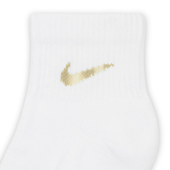 White quarter sock close-up with gold Nike swoosh logo on ankle