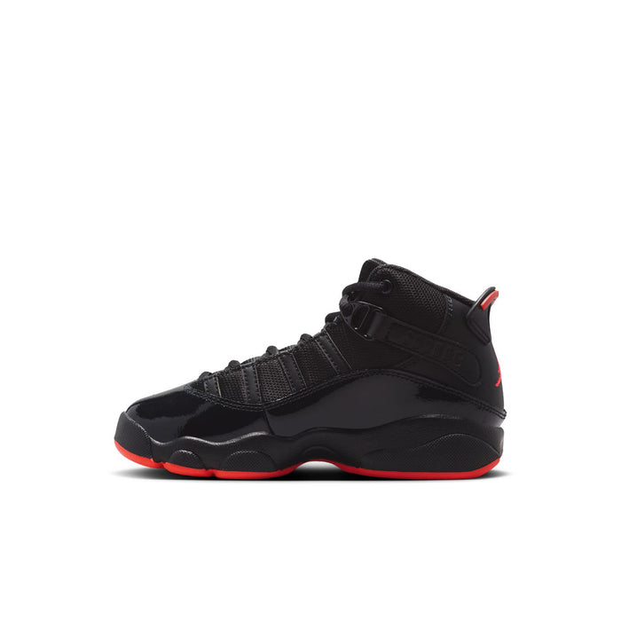 Kids black high-top sneaker with strap detailing and red outsole trim, side view